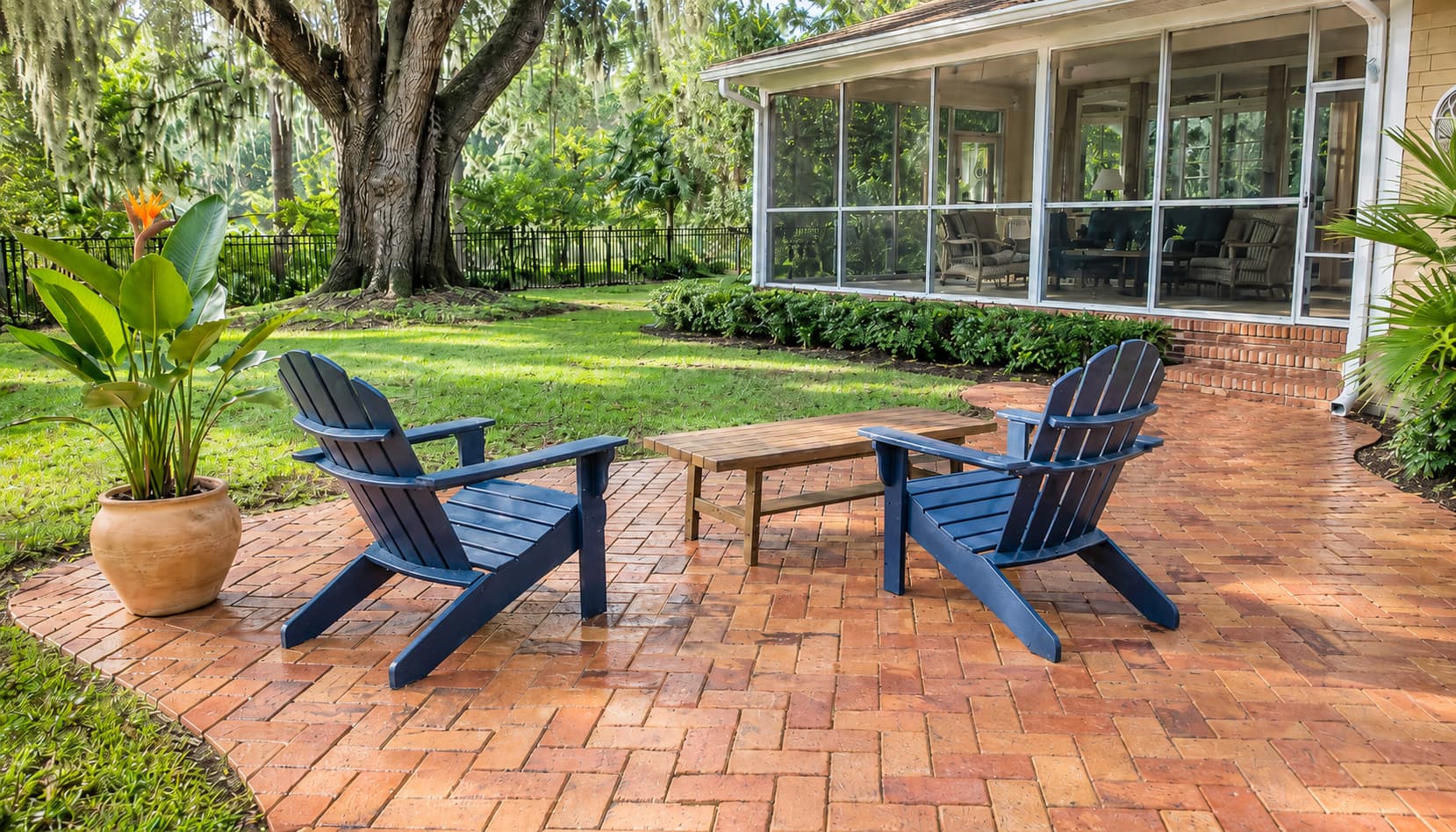 Herringbone paver patio with Adirondack chairs at golden hour — cleaned and ready for entertaining